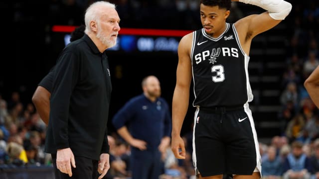 Jan 2, 2024; Memphis, Tennessee, USA; San Antonio Spurs head coach Gregg Popovich (left) talks with forward Keldon Johnson (3) during the second half against the Memphis Grizzlies at FedEx Forum.